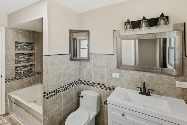 bathroom featuring vanity, a bath, tile walls, and toilet