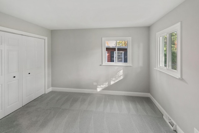 unfurnished bedroom featuring carpet floors and a closet