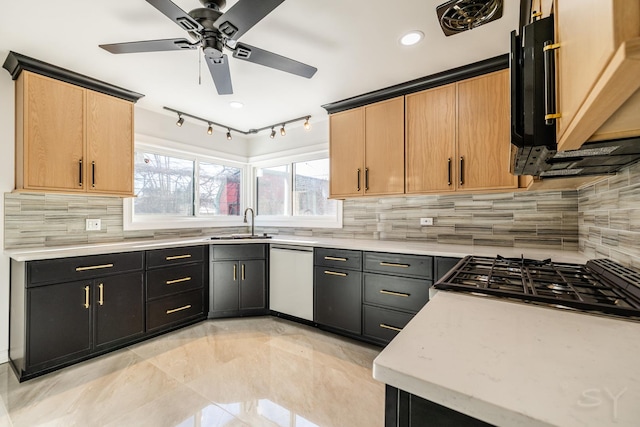 kitchen featuring sink, ceiling fan, light brown cabinetry, tasteful backsplash, and dishwashing machine