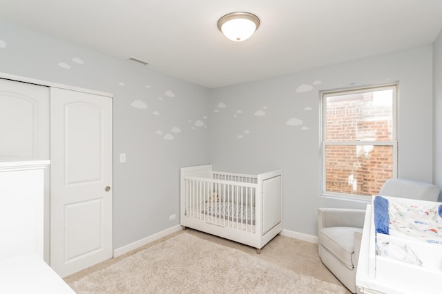 carpeted bedroom with a nursery area