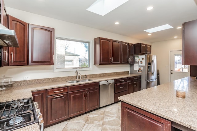 kitchen featuring a wealth of natural light, sink, appliances with stainless steel finishes, and a skylight