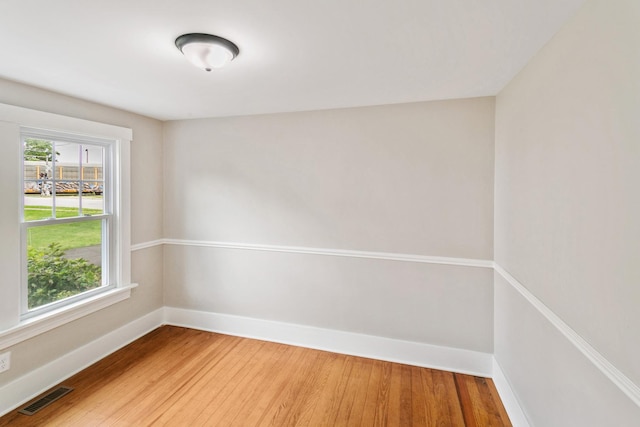 spare room with hardwood / wood-style flooring