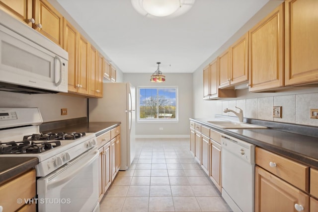 kitchen with white appliances, hanging light fixtures, sink, light tile patterned floors, and light brown cabinetry