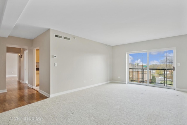 unfurnished room with dark colored carpet