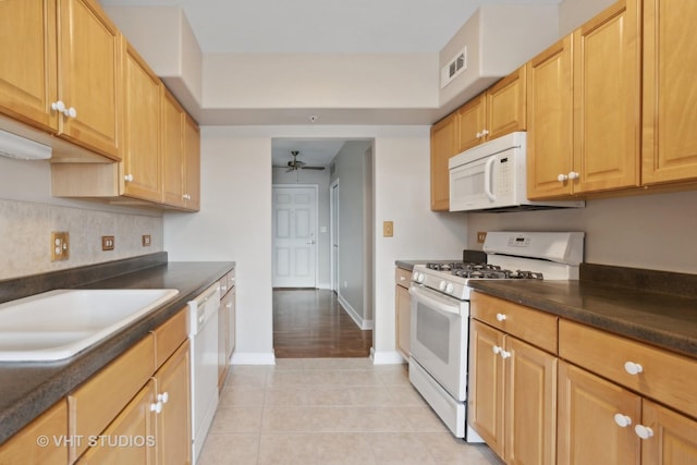 kitchen with ceiling fan, white appliances, sink, and light tile patterned floors