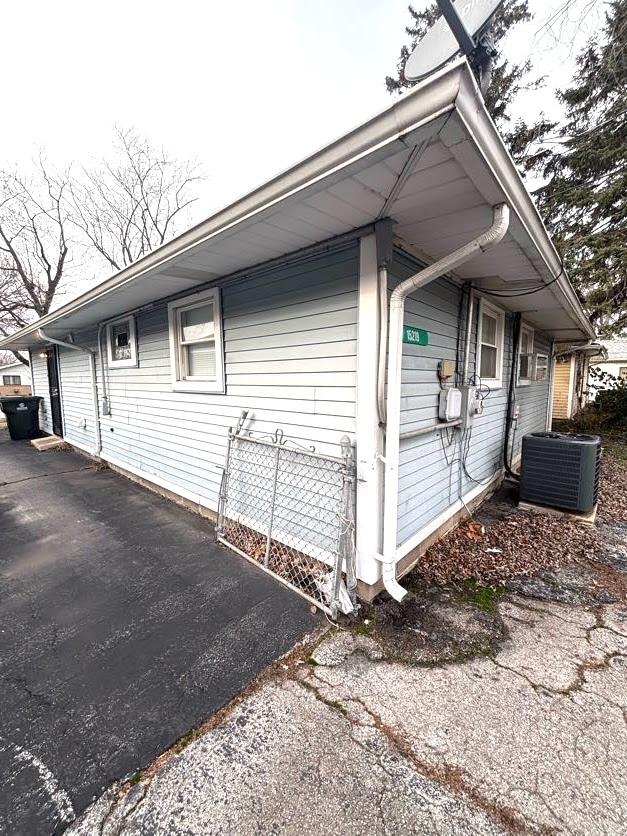 view of side of property featuring central AC