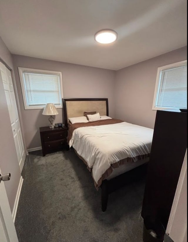 bedroom featuring dark colored carpet