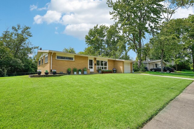 ranch-style house with a garage and a front lawn