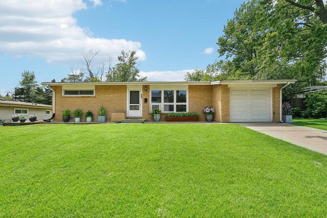 single story home featuring a garage and a front lawn