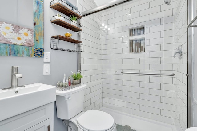 bathroom featuring an enclosed shower, vanity, and toilet