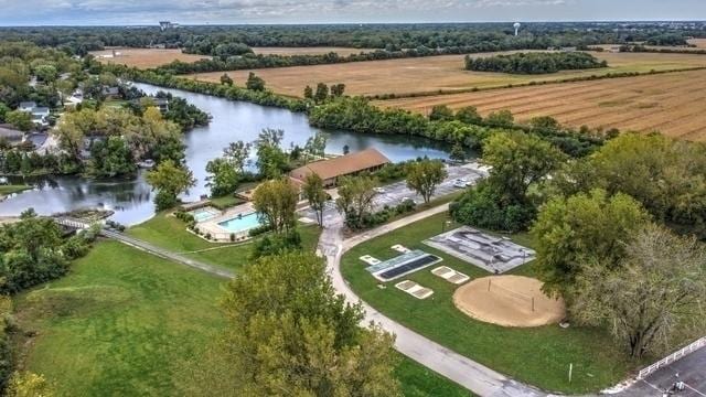 birds eye view of property with a water view and a rural view