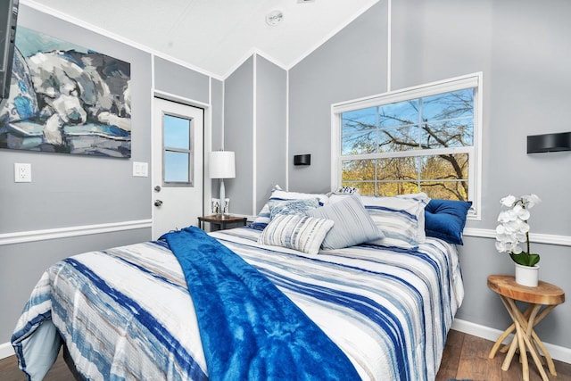 bedroom featuring lofted ceiling, dark wood-type flooring, and ornamental molding