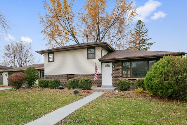 tri-level home with a front yard