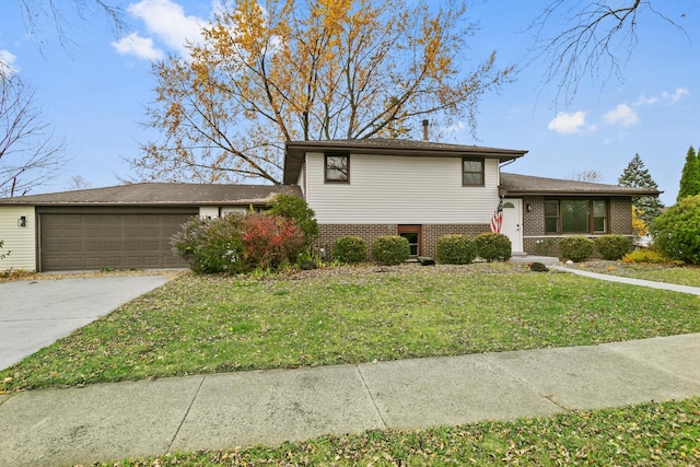 split level home featuring a garage and a front lawn