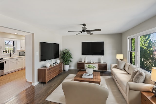 living room featuring ceiling fan, dark hardwood / wood-style flooring, and sink