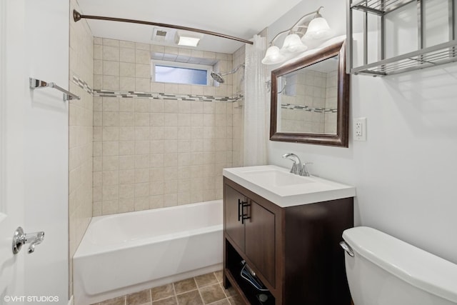 full bathroom with tile patterned flooring, vanity, toilet, and tiled shower / bath