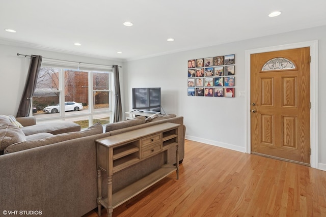 living room with light hardwood / wood-style flooring and crown molding