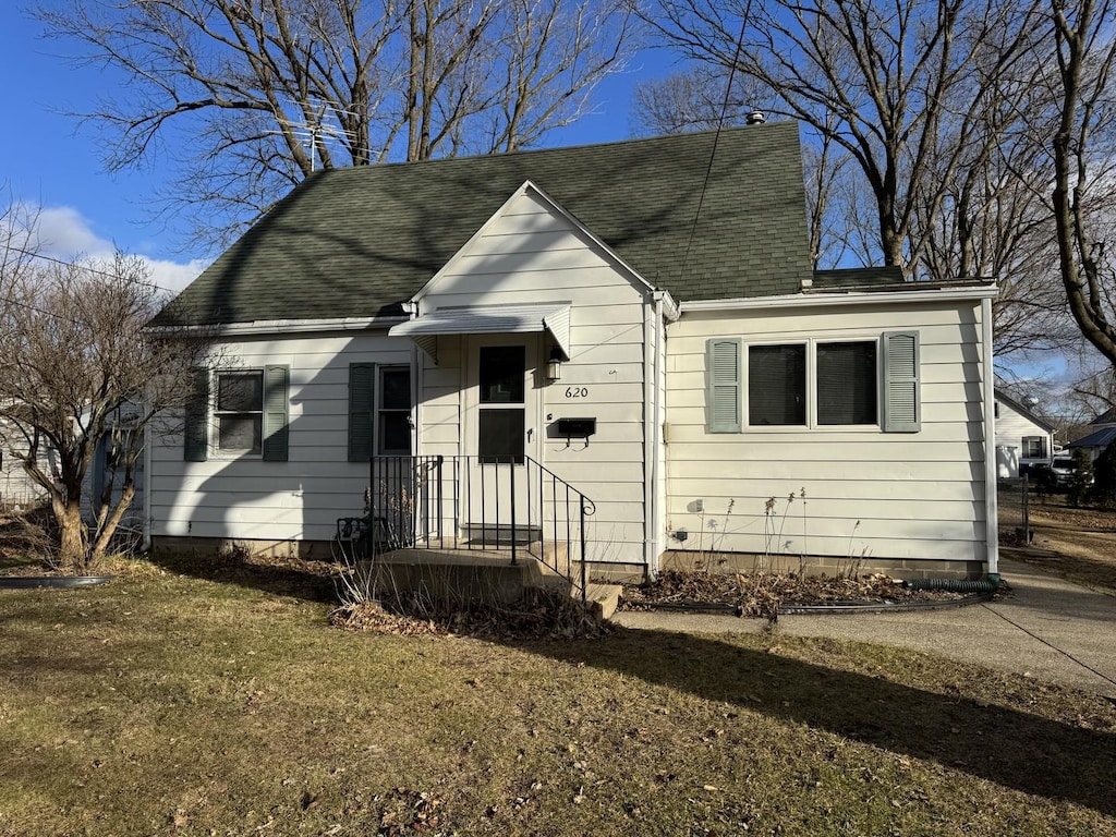 bungalow-style home with a front yard