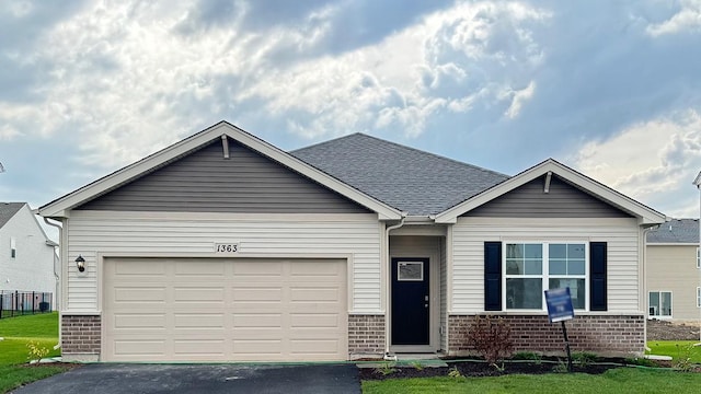 view of front facade featuring a front lawn and a garage