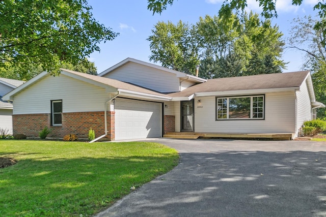 view of front of house with a front lawn and a garage