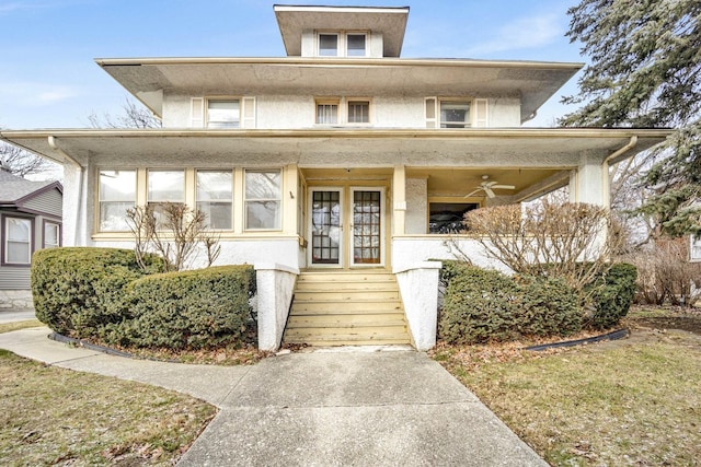 view of front of home with ceiling fan and french doors