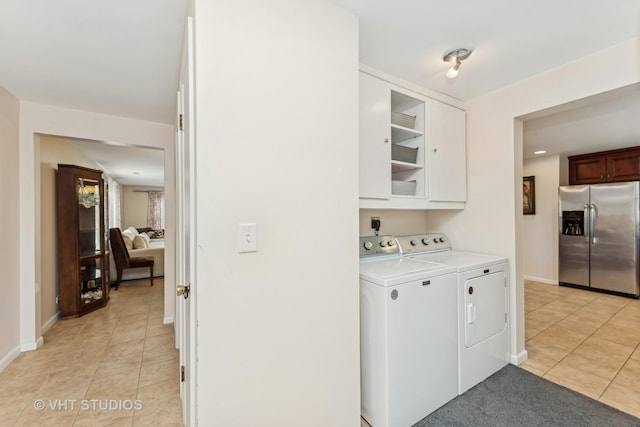 washroom featuring washer and clothes dryer and light tile patterned flooring