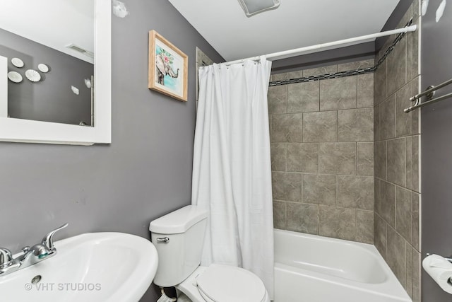 full bathroom featuring shower / bath combo, toilet, and sink