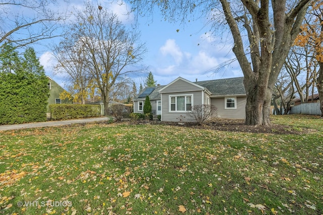 ranch-style home with solar panels and a front yard