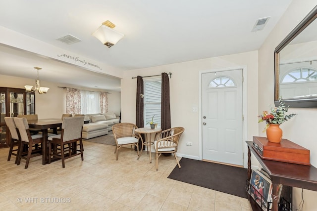 entryway featuring an inviting chandelier