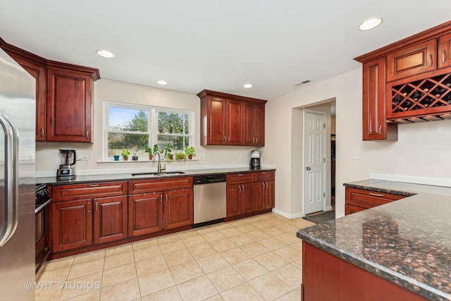 kitchen featuring appliances with stainless steel finishes, light tile patterned floors, and sink