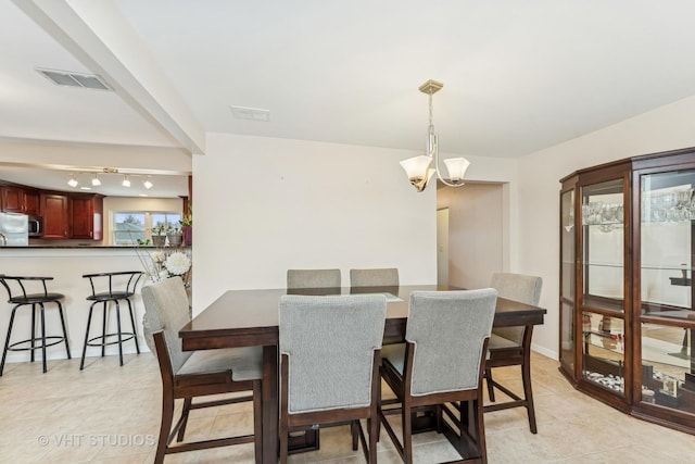 dining area with an inviting chandelier