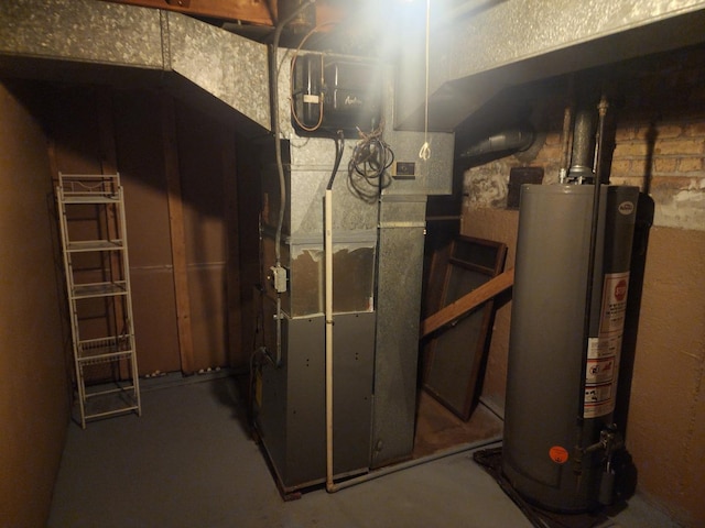 utility room featuring heating unit and water heater