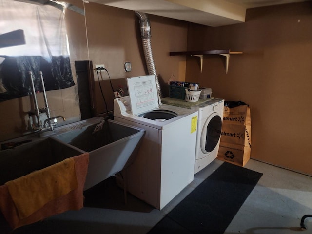 laundry area featuring washing machine and dryer and sink