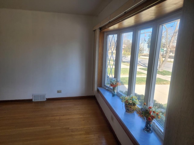 unfurnished room featuring hardwood / wood-style flooring