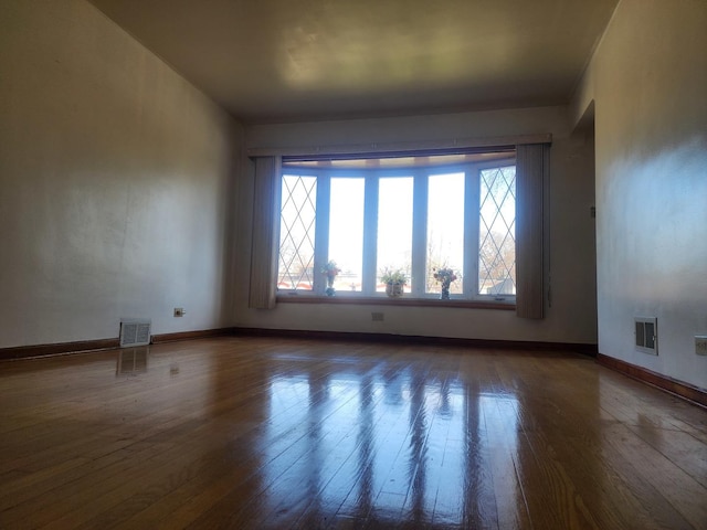 spare room with dark hardwood / wood-style floors