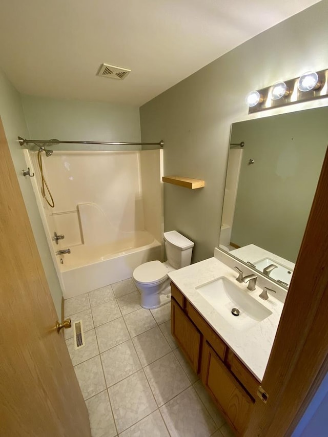 full bathroom with tile patterned floors, vanity, toilet, and  shower combination