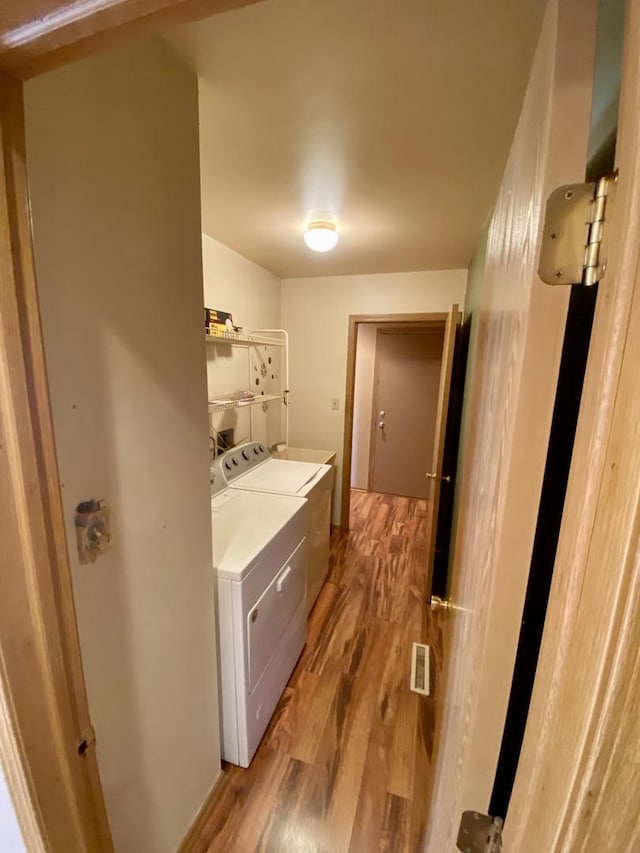 bathroom featuring washer and dryer and wood-type flooring