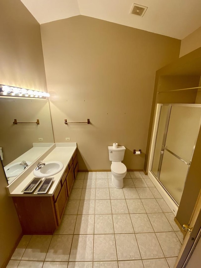 bathroom with tile patterned flooring, vanity, a shower with shower door, and lofted ceiling