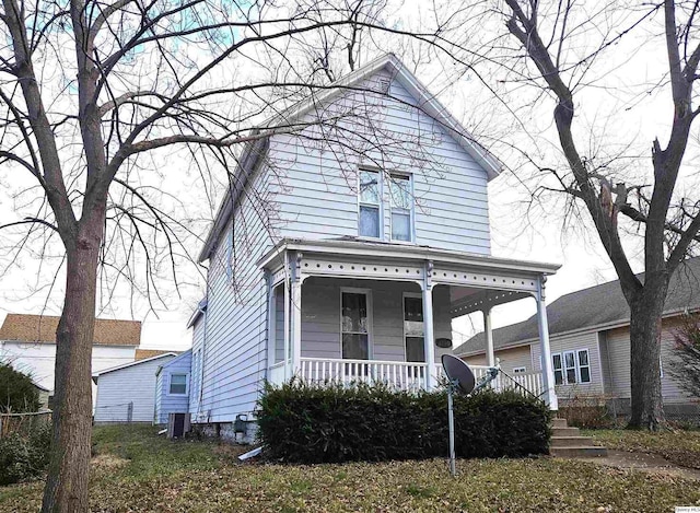 view of front facade featuring central AC and covered porch