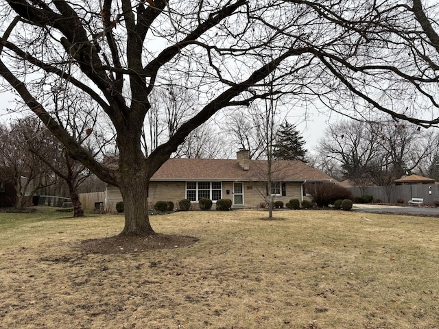 rear view of house featuring a lawn