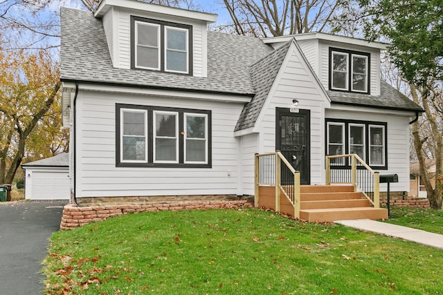 view of front facade with a garage and a front yard