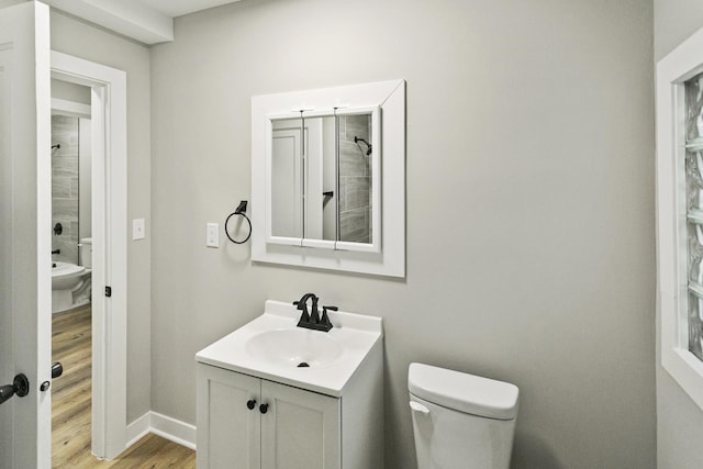 bathroom featuring hardwood / wood-style flooring, vanity, and toilet