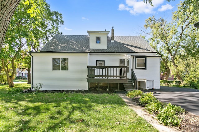 rear view of house with a yard and a wooden deck