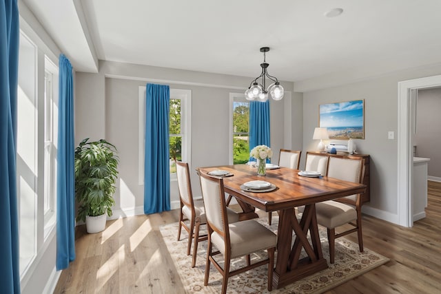 dining space featuring a chandelier and light hardwood / wood-style floors