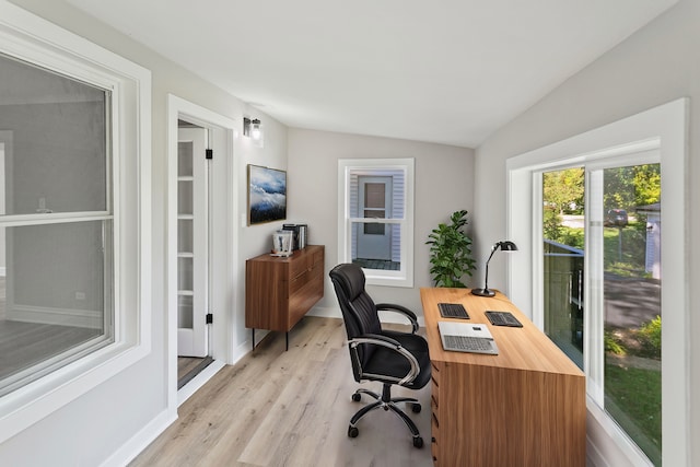 office area featuring lofted ceiling and light hardwood / wood-style flooring