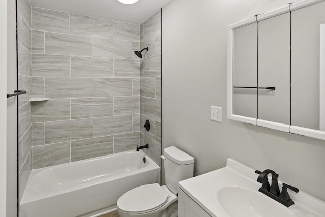 full bathroom with tiled shower / bath combo, toilet, and vanity