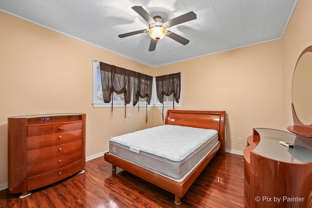 bedroom with dark hardwood / wood-style floors and ceiling fan