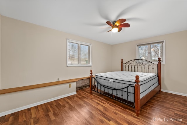 bedroom with ceiling fan and dark wood-type flooring