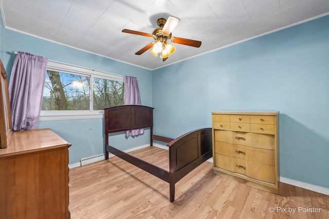 bedroom with light wood-type flooring, baseboard heating, ceiling fan, and ornamental molding