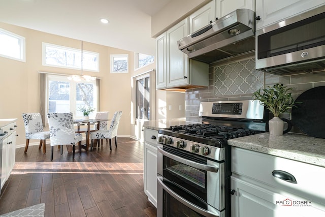 kitchen featuring decorative backsplash, dark wood-type flooring, stainless steel appliances, and white cabinets